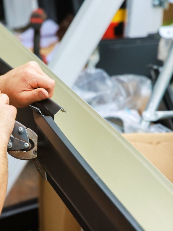Aluminum rain gutters have been bent by a machine tool then cut with shears to required size