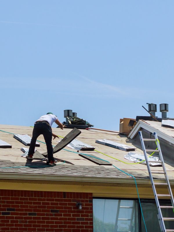 Home roof construction applying roof new shingles in apartment building Home roof construction applying roof new shingles in apartment building